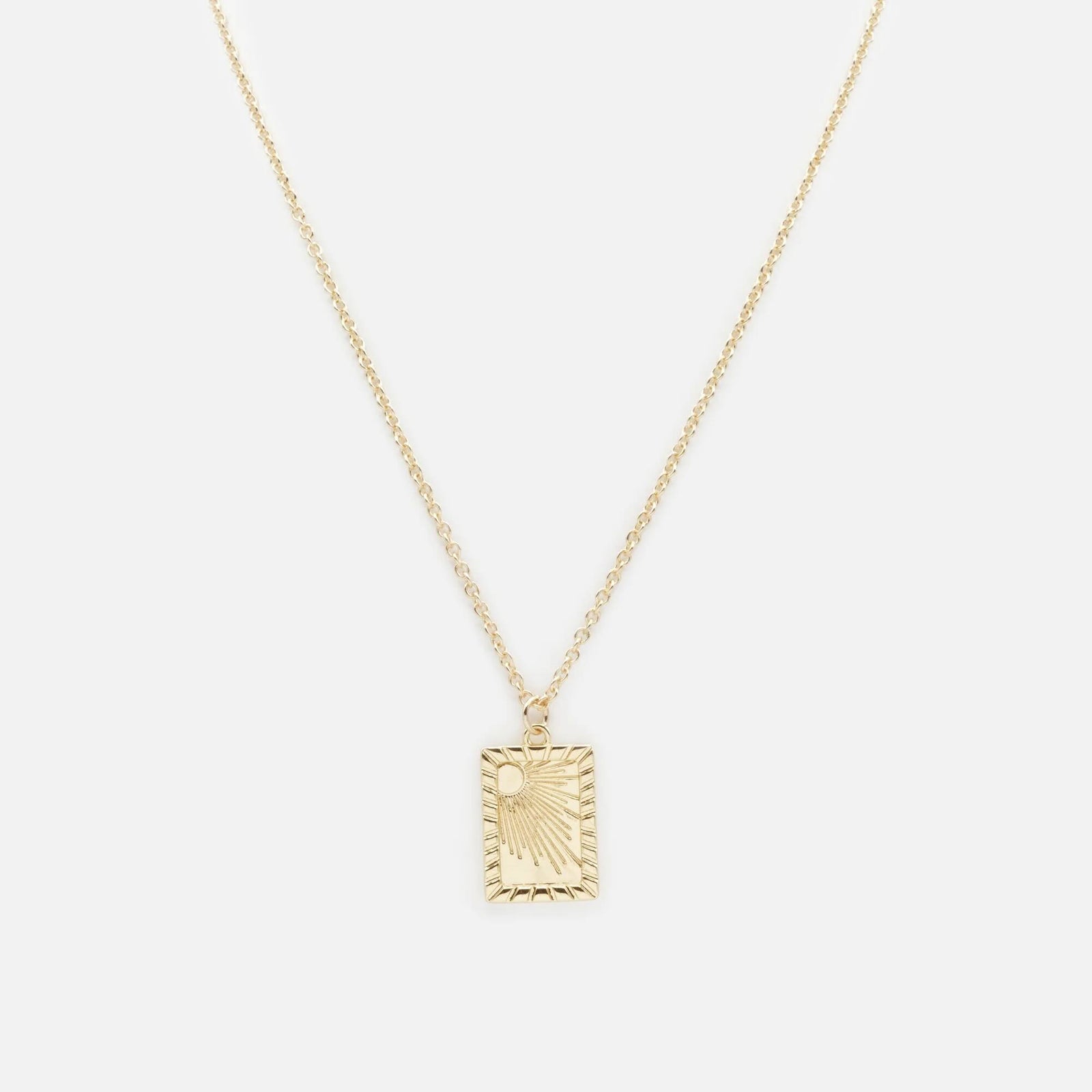 Golden Sun Necklace with a rectangular sun-engraved pendant on a delicate gold chain.