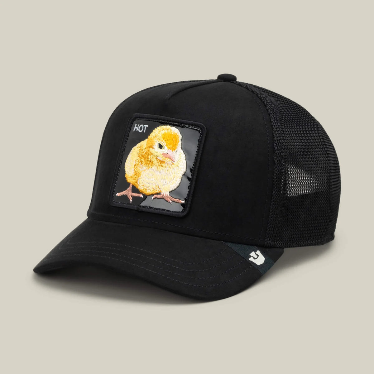 Black trucker hat with mesh back featuring a glossy front patch with a yellow chick embroidery and "HOT" text.