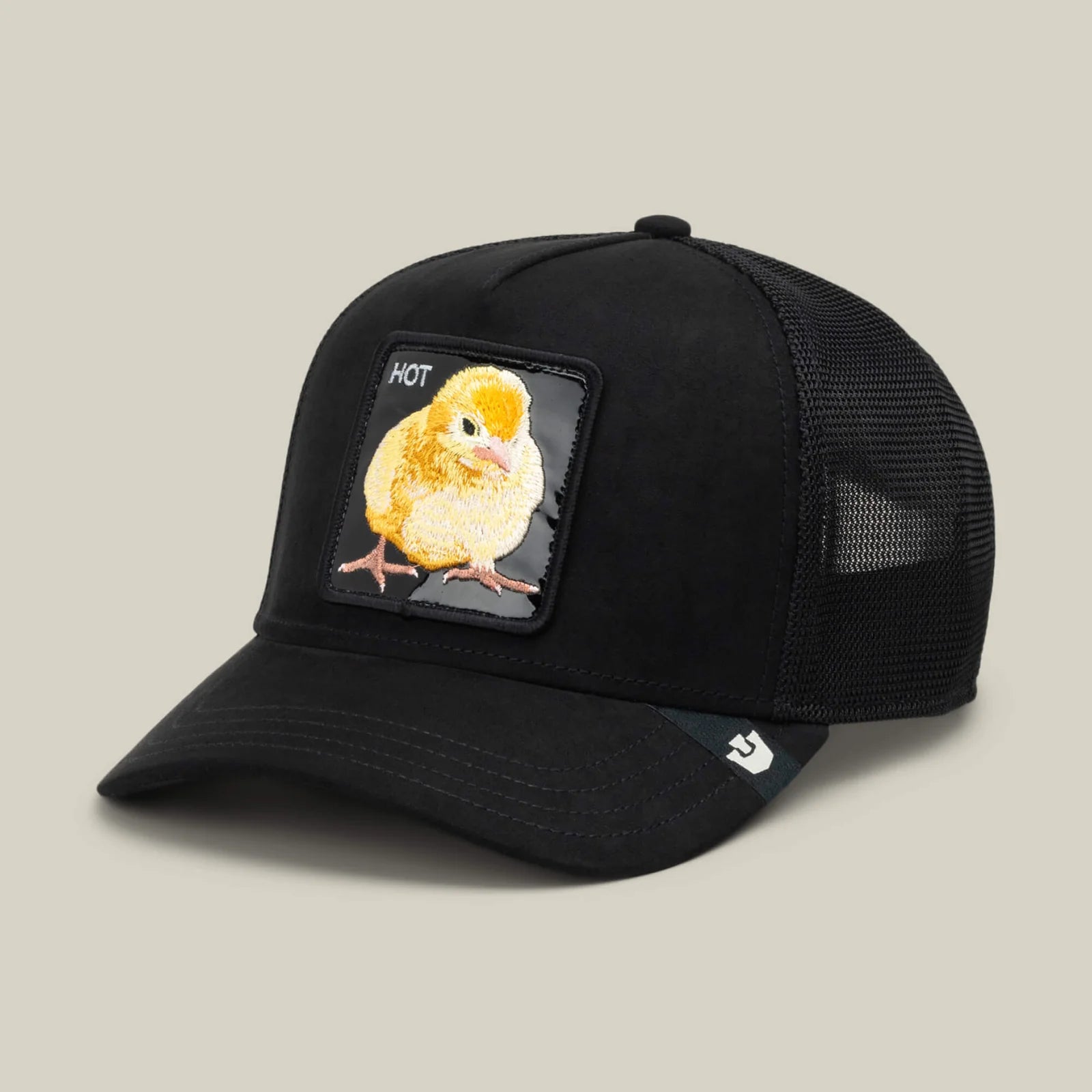 Black trucker hat with mesh back featuring a glossy front patch with a yellow chick embroidery and "HOT" text.