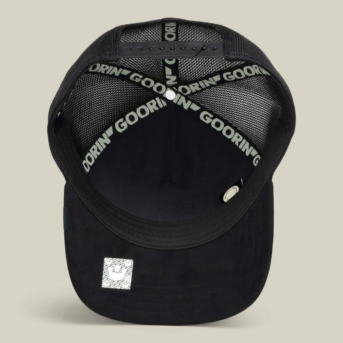 Back view of the Goorin Black Out Chick Trucker Hat featuring printed inner bands and a reflective crown emblem on the bill.