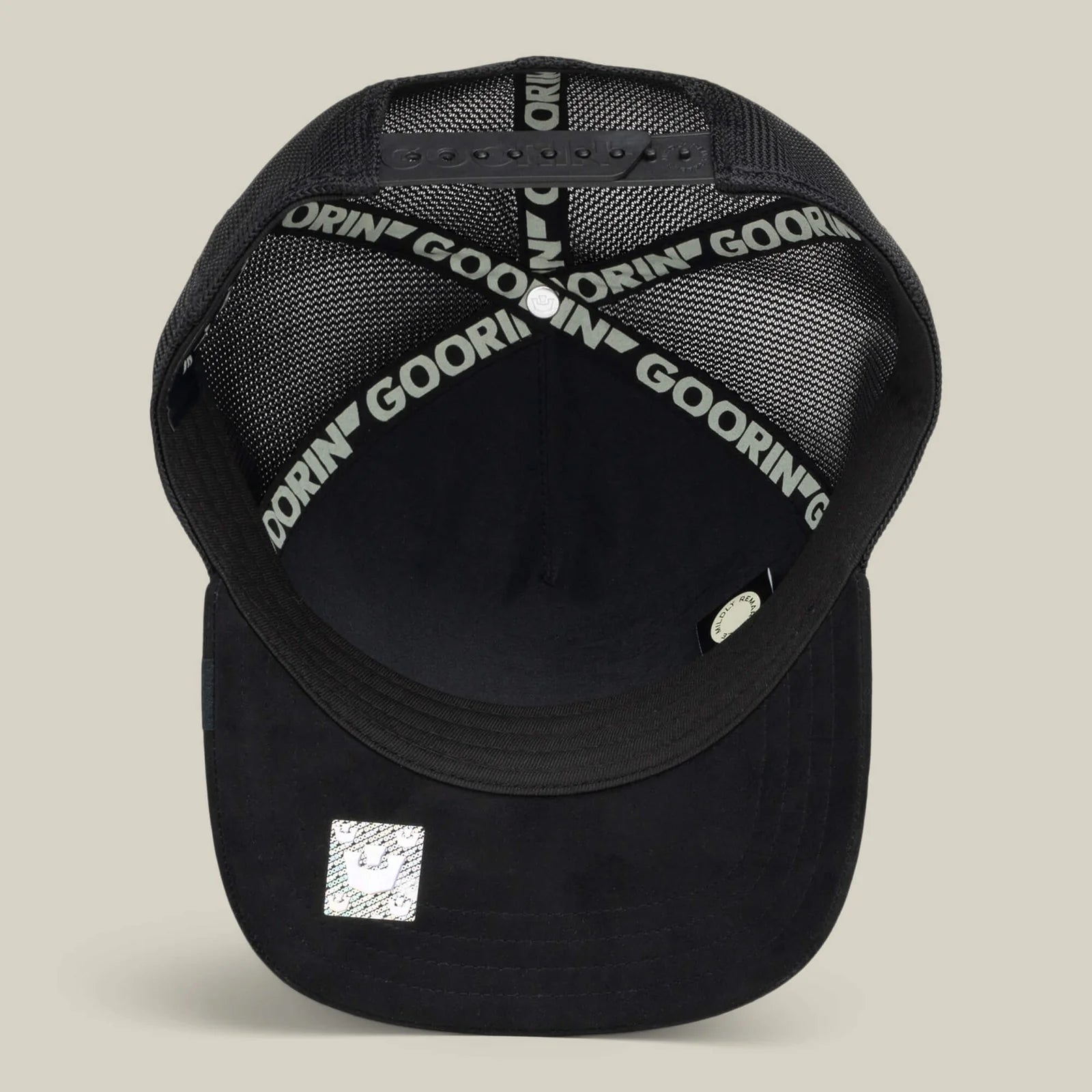 Back view of the Goorin Black Out Chick Trucker Hat featuring printed inner bands and a reflective crown emblem on the bill.
