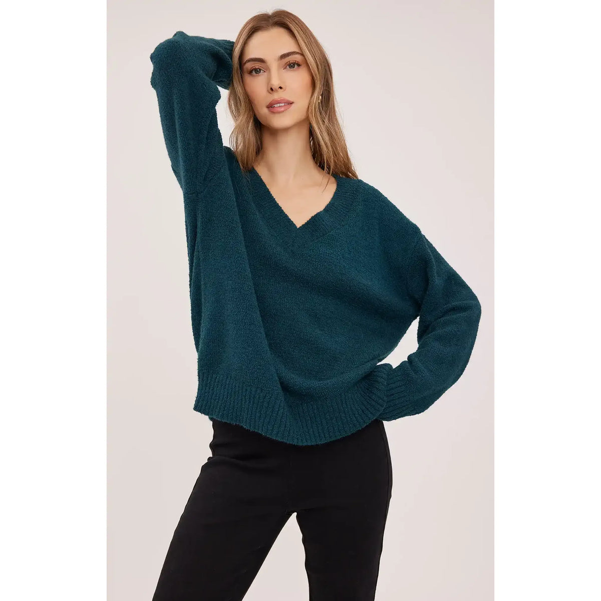 Teal oversized v-neck sweater with soft bouclé texture, ribbed cuffs, and hem for a cozy, casual look.