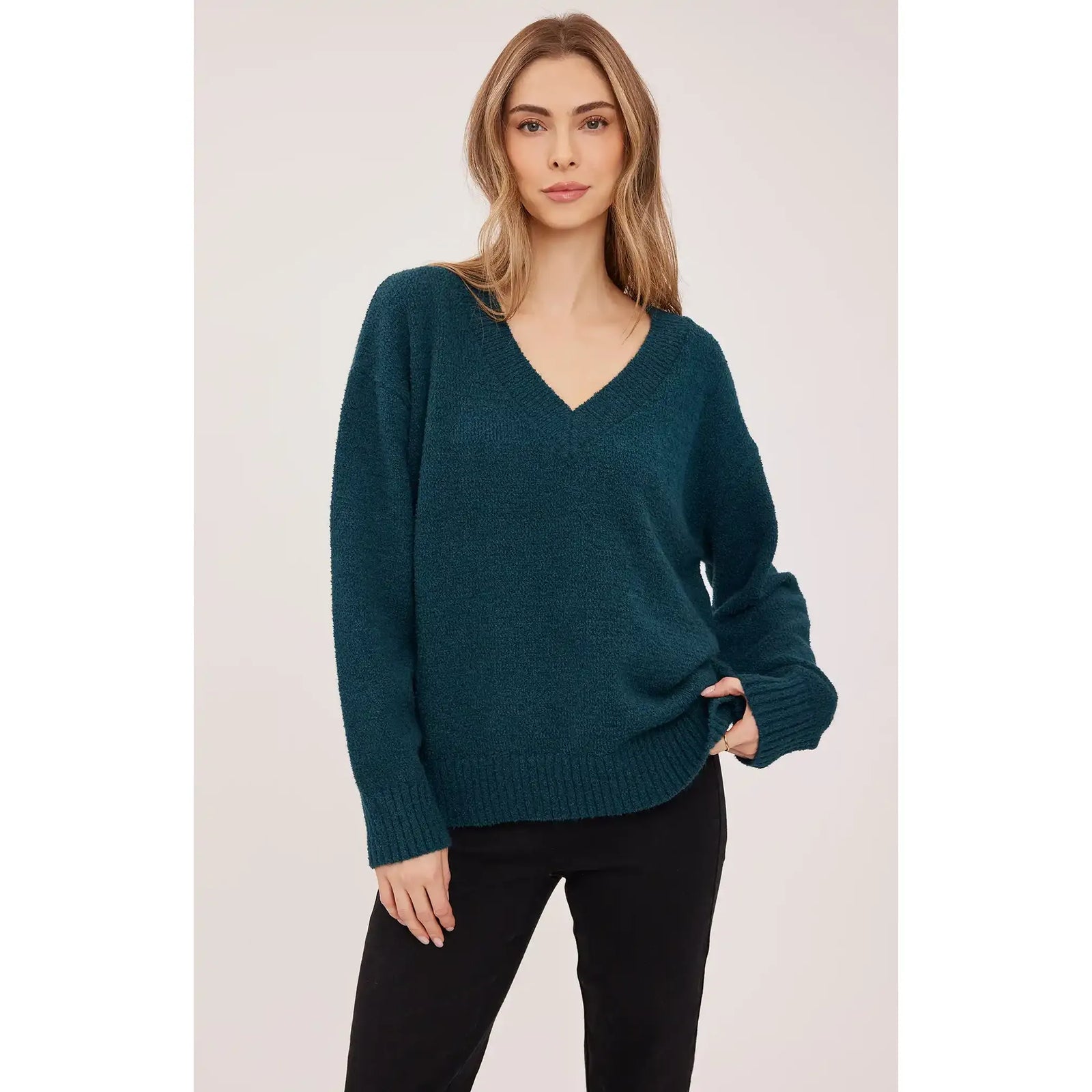 Teal oversized V-neck sweater in soft textured bouclé yarn with ribbed cuffs and hem for a cozy, casual look.