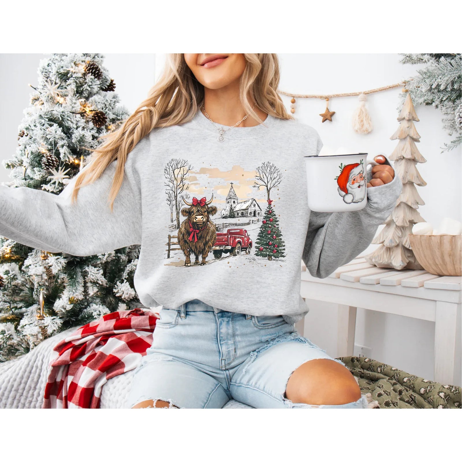 Highland Christmas Crew sweatshirt featuring a festive bull, a red farm truck, and a church in a snowy holiday scene.