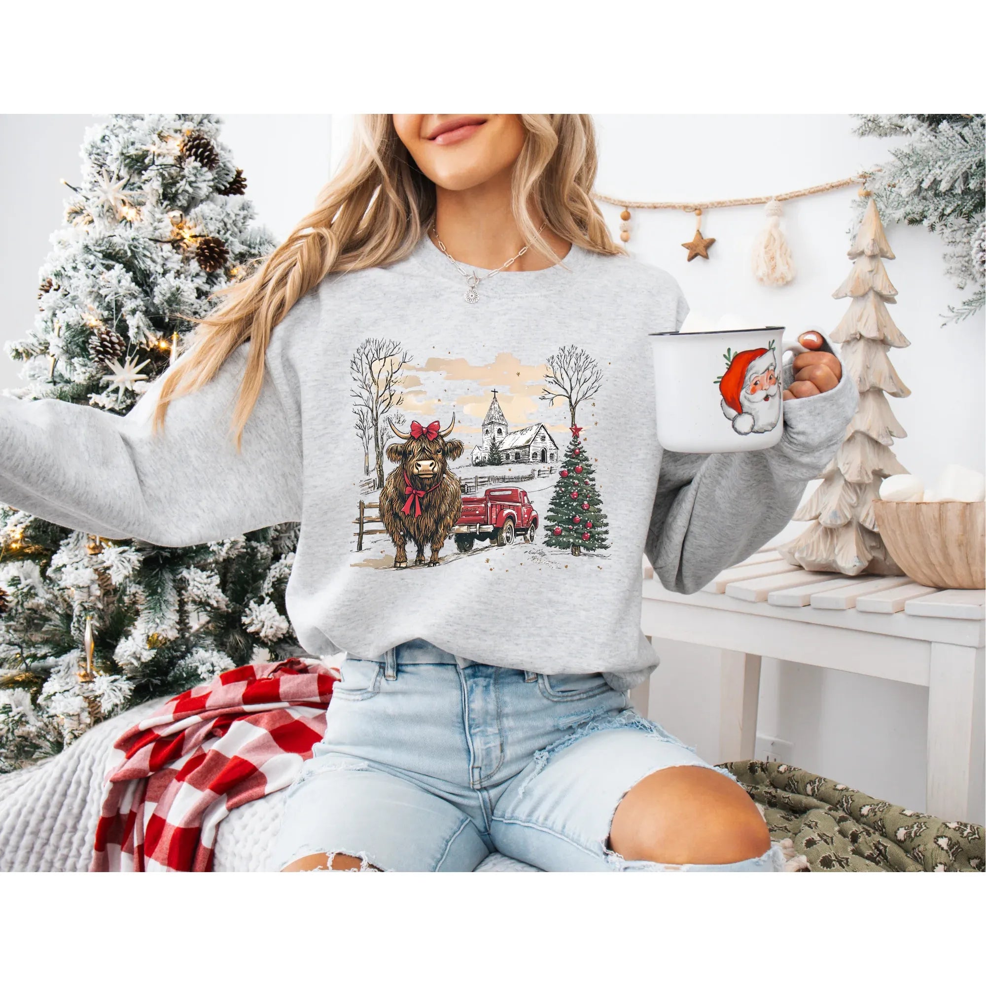 Highland Christmas Crew sweatshirt featuring a festive bull, a red farm truck, and a church in a snowy holiday scene.