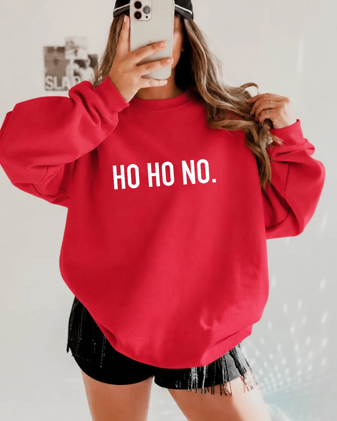 Red holiday crewneck sweatshirt featuring bold white "HO HO NO." text across the chest for a cheeky festive style.
