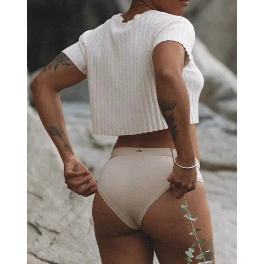 HuHa Cheeky Mineral Undies beige, body-contouring back-view underwear on model outdoors.
