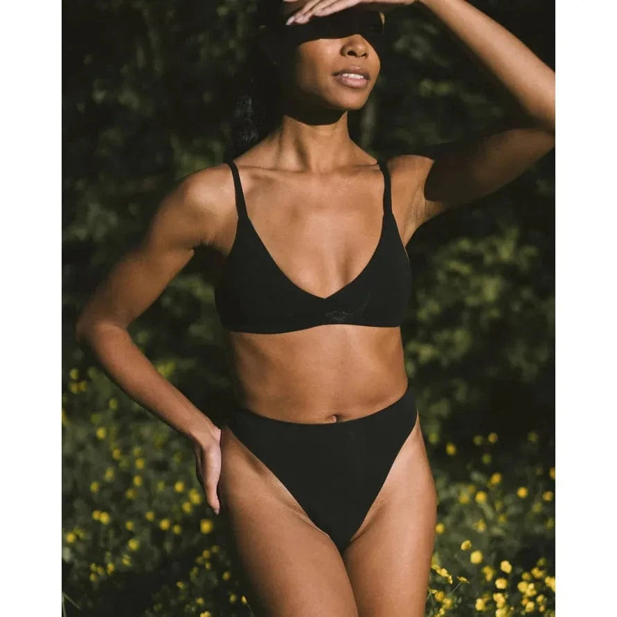 HuHa Seamless High Rise Thong worn by model in black, breathable tree-fiber fabric, lighter and stretchy outdoors.