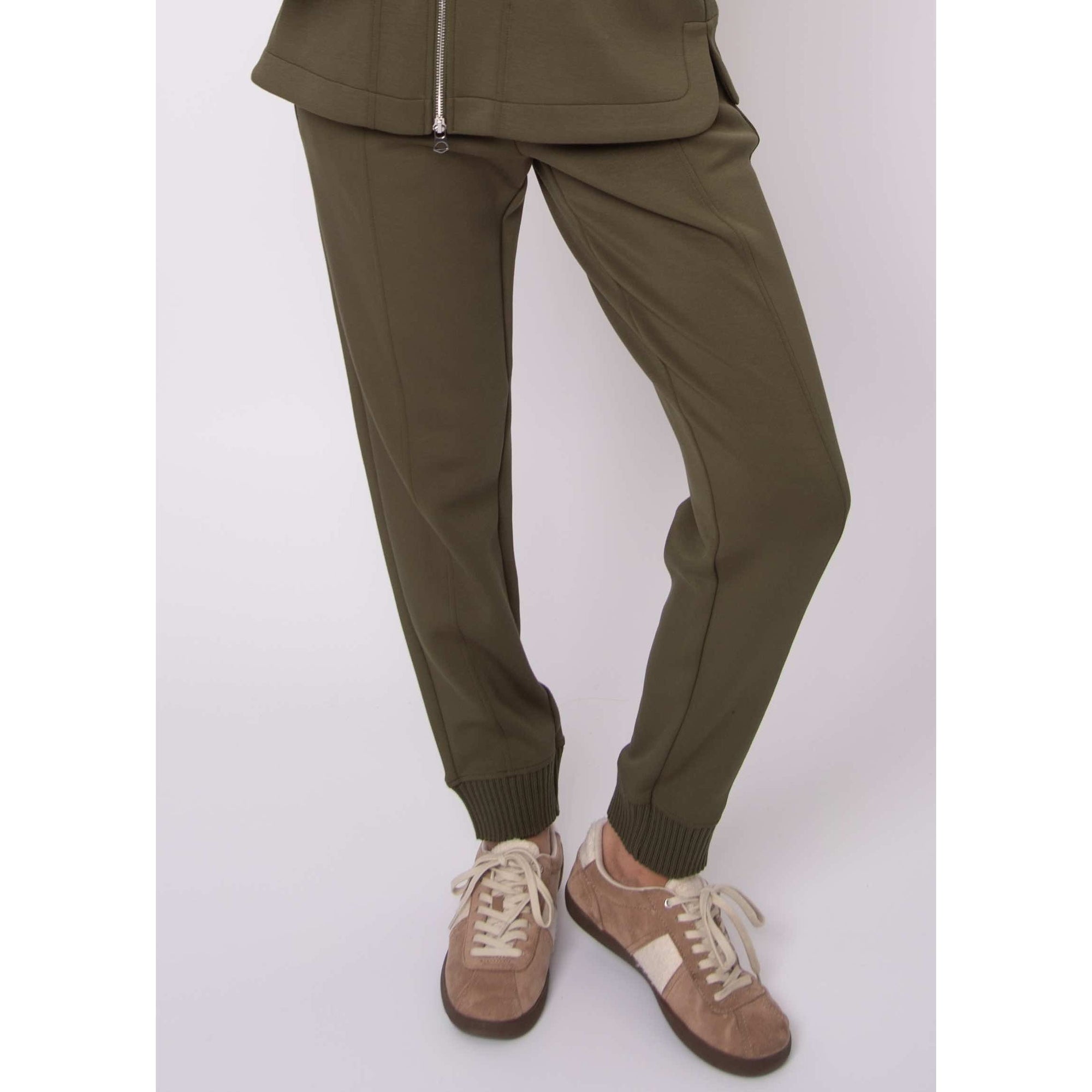 Joselle soft knit pull-on jogger pants in olive with drawstring waist and ribbed cuffs, shown with beige sneakers.