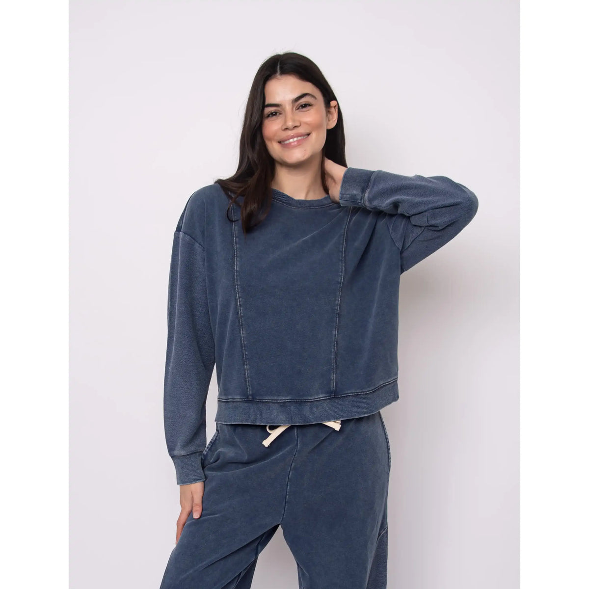Model wearing Kacey French Terry Pull Over Crew Top in denim-inspired blue with matching joggers.