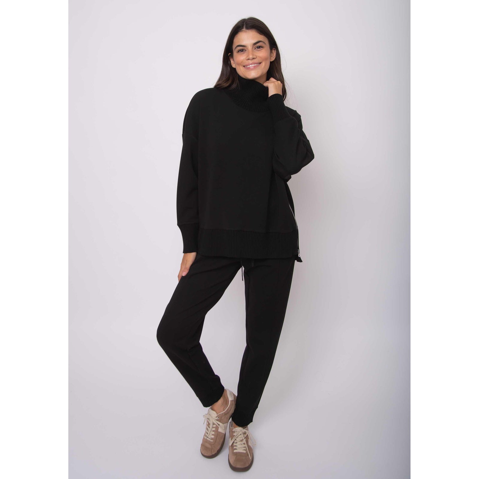 Katelyn Soft Knit Sweater on model: oversized black modal knit with ribbed cowl neck, matching hems, side zipper.