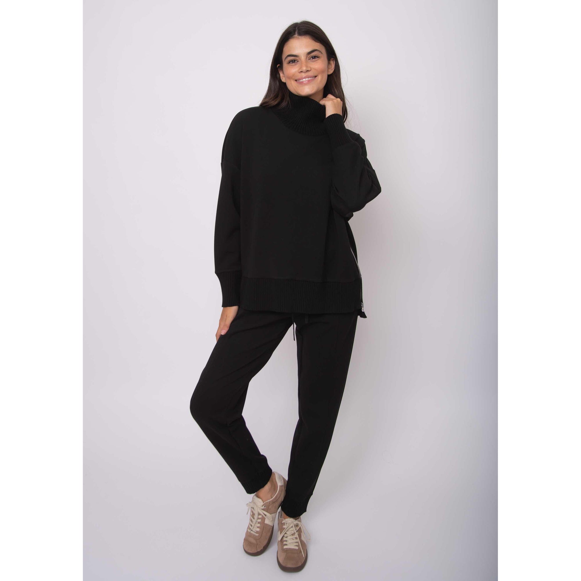 Katelyn Soft Knit Sweater on model: oversized black modal knit with ribbed cowl neck, matching hems, side zipper.