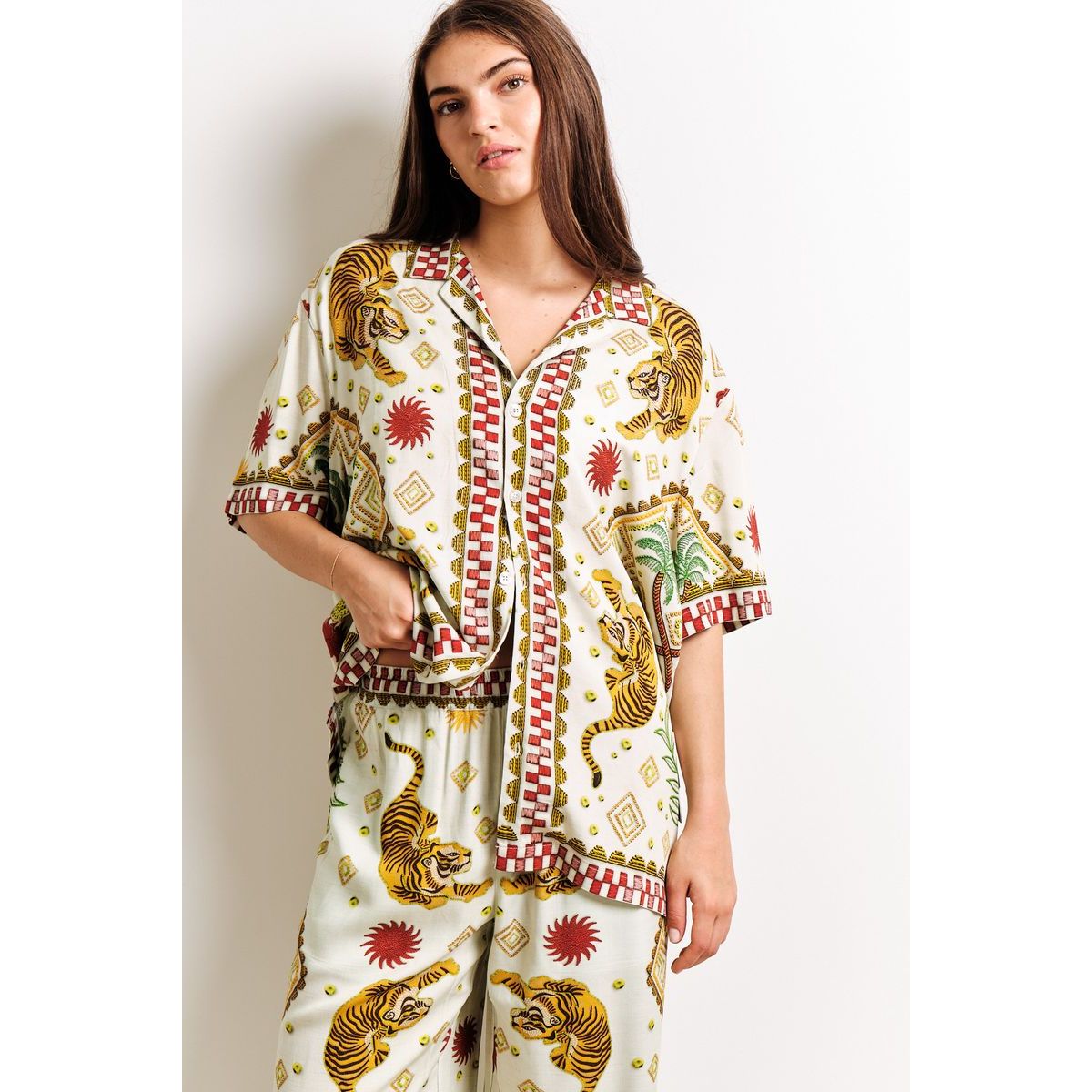 Model wearing Kuwalla Beach Shirt Tiger Cream - relaxed tiger-print cream beach shirt for coastal style.