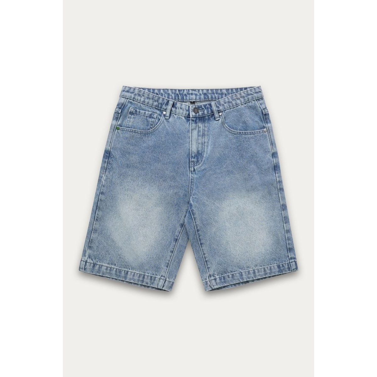 Kuwalla Bermuda Denim Shorts in dark denim, knee-length, worn by a man in a pink sweatshirt and white sneakers.