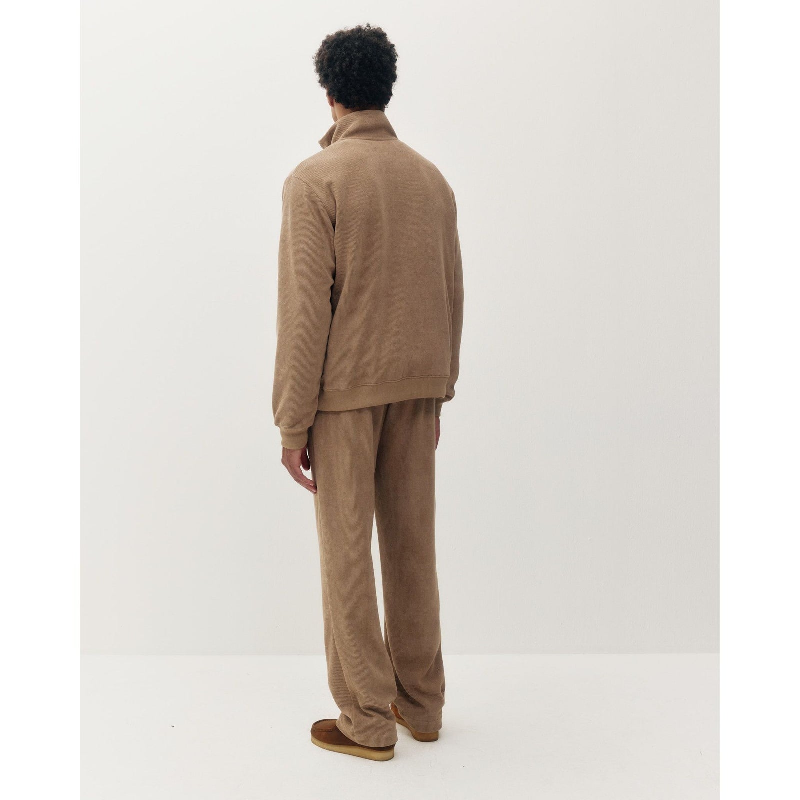Back view of a tan chenille 1/4 zip sweatshirt and matching pants set featuring a plush, textured fabric and relaxed fit.
