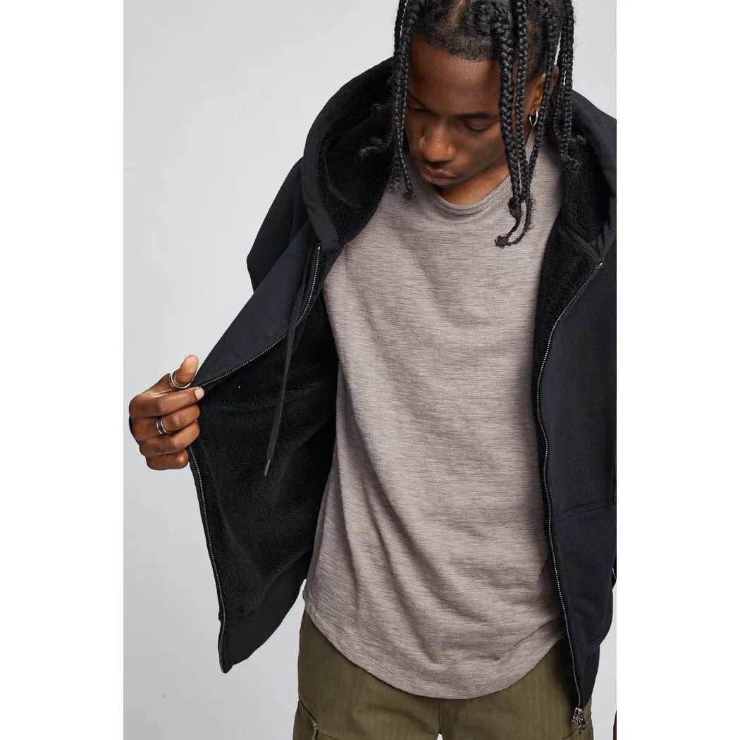 Kuwalla Slub Hi-Lo Tee on male model; curved hi-lo hem, slub textured fabric, bound neck collar.