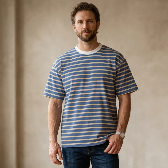 Kuwalla Striped Tee on a man with blue and beige horizontal stripes, white crew neck, relaxed fit.