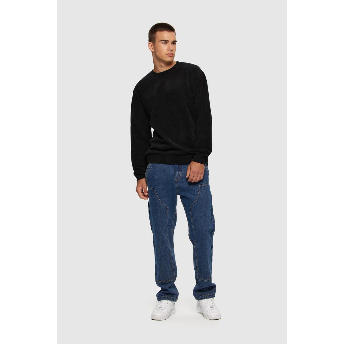Kuwalla Textured Knit Crew on a model in a black knit crewneck with blue jeans — Kuwalla.