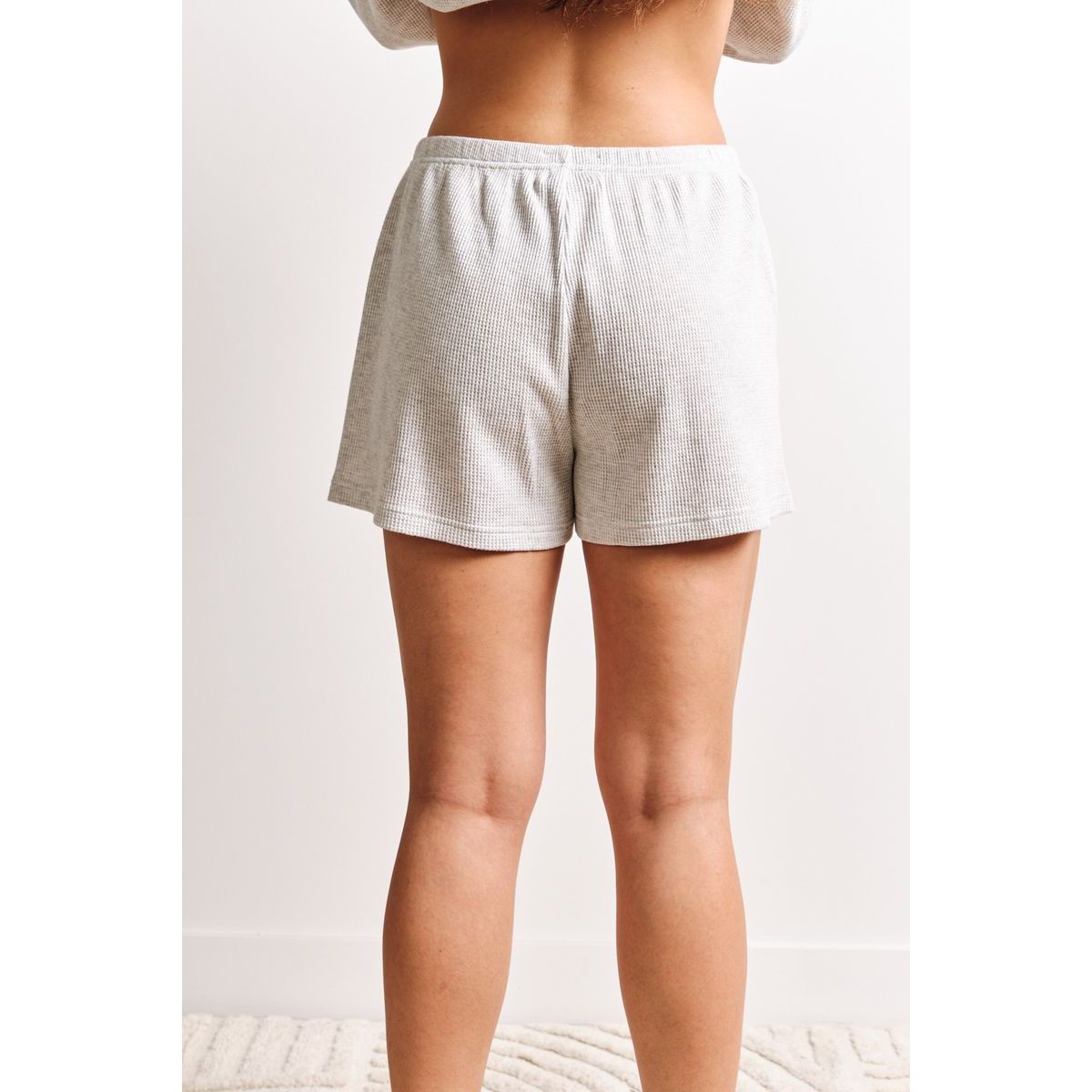 Kuwalla Tyla Waffle Shorts in light gray waffle fabric, back view, relaxed fit with elastic waistband.