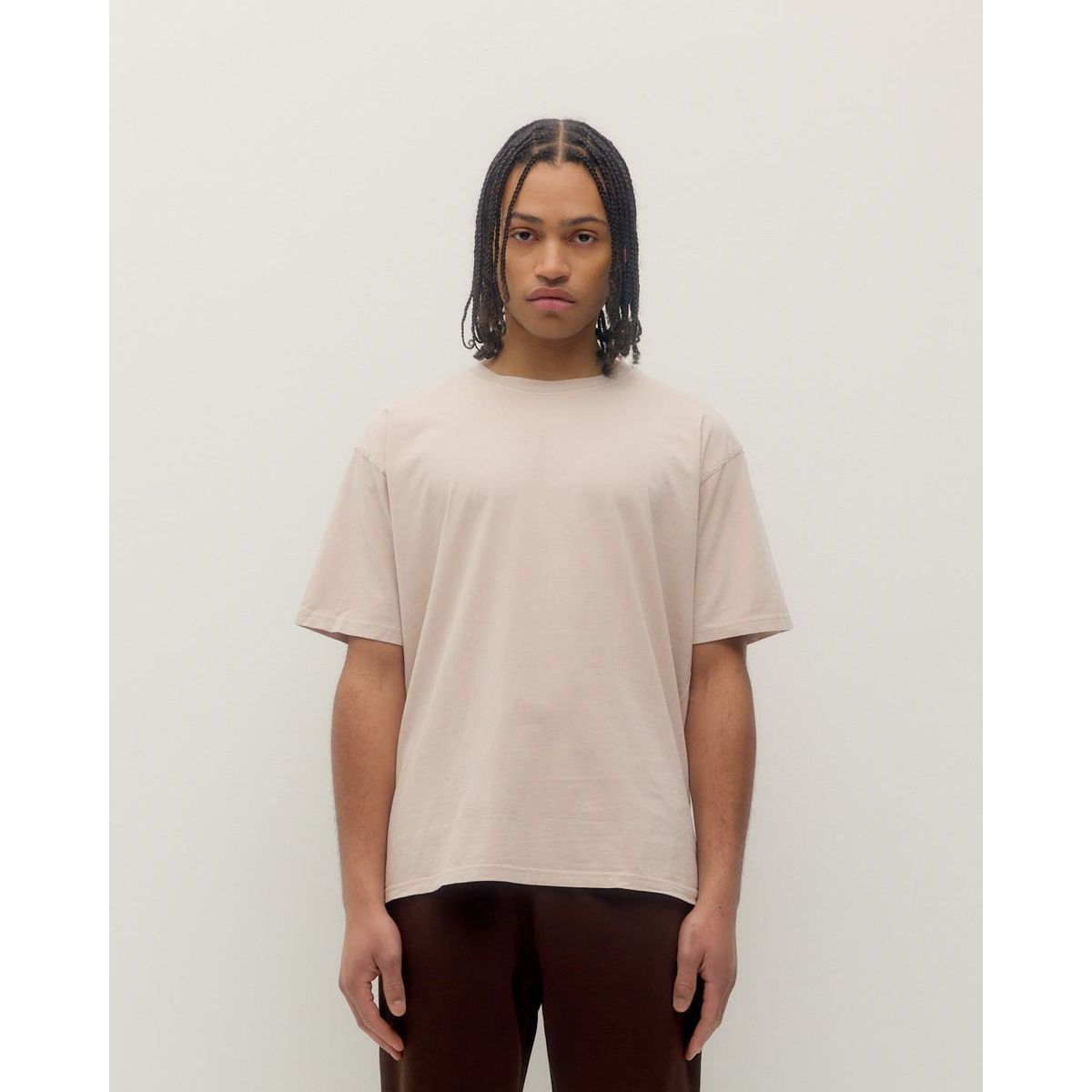 Model wearing a soft beige Kuwalla Vintage Tee with a relaxed fit for casual summer vibes.