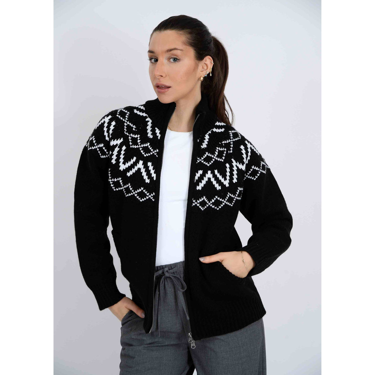 Leocadia Mock Neck Zip Cardigan in black with a white geometric yoke, worn by a model.