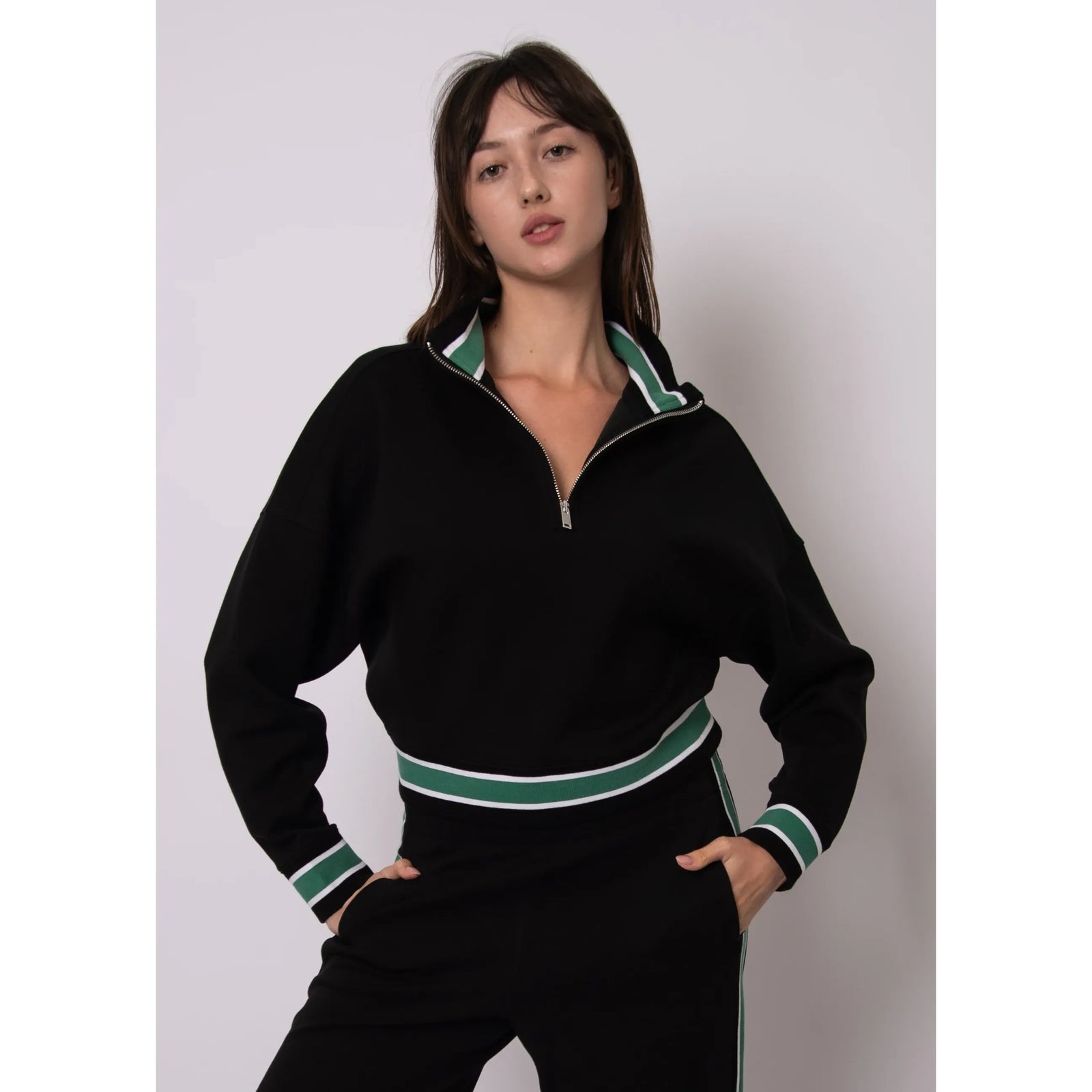 Woman wearing black Mailyn Soft Knit half-zip pullover with green and white striped collar, cuffs, and hem.