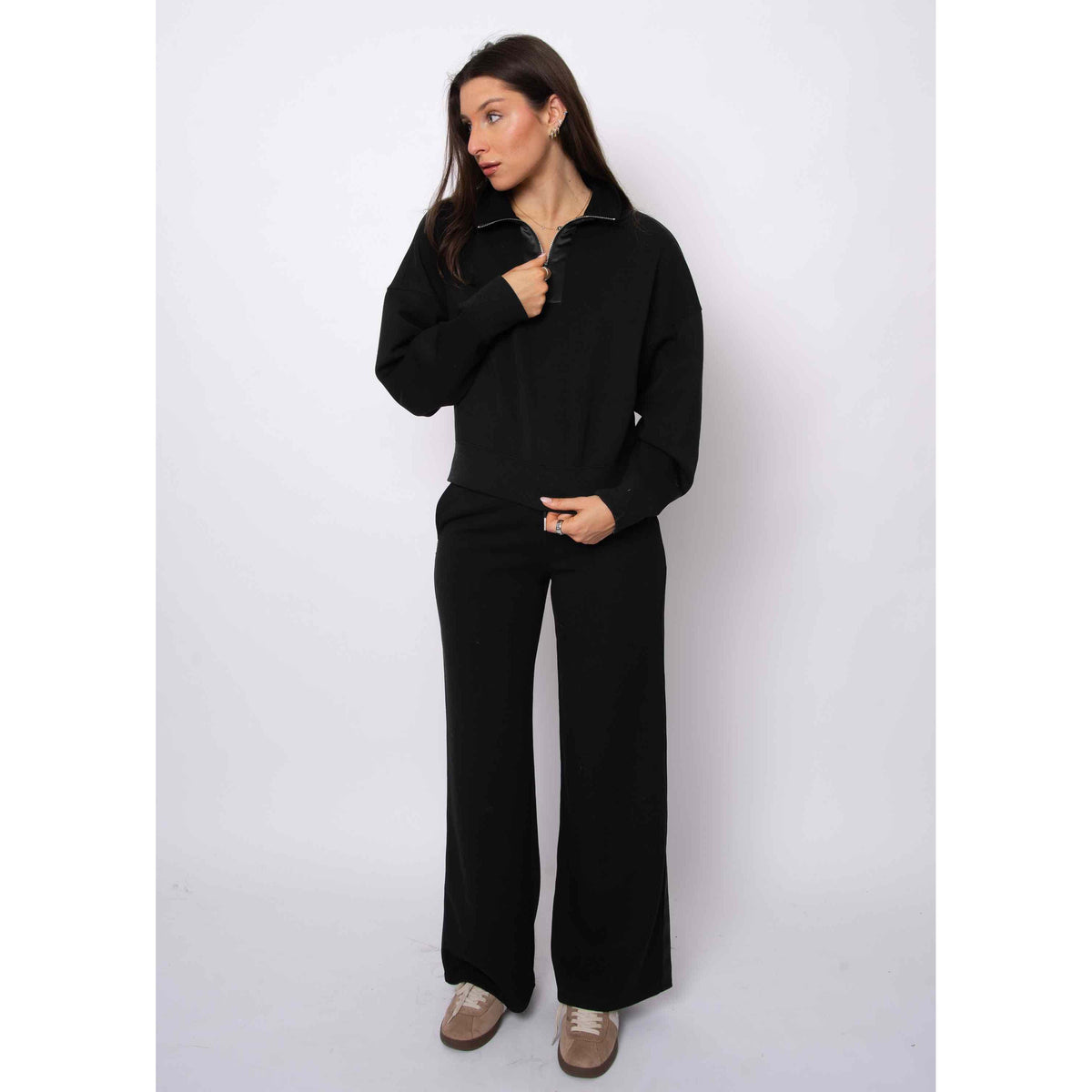 Woman wearing Mailyn Soft Knit w/ Satin Trim 1/2 Zip black cropped pullover with satin trim, relaxed fit.