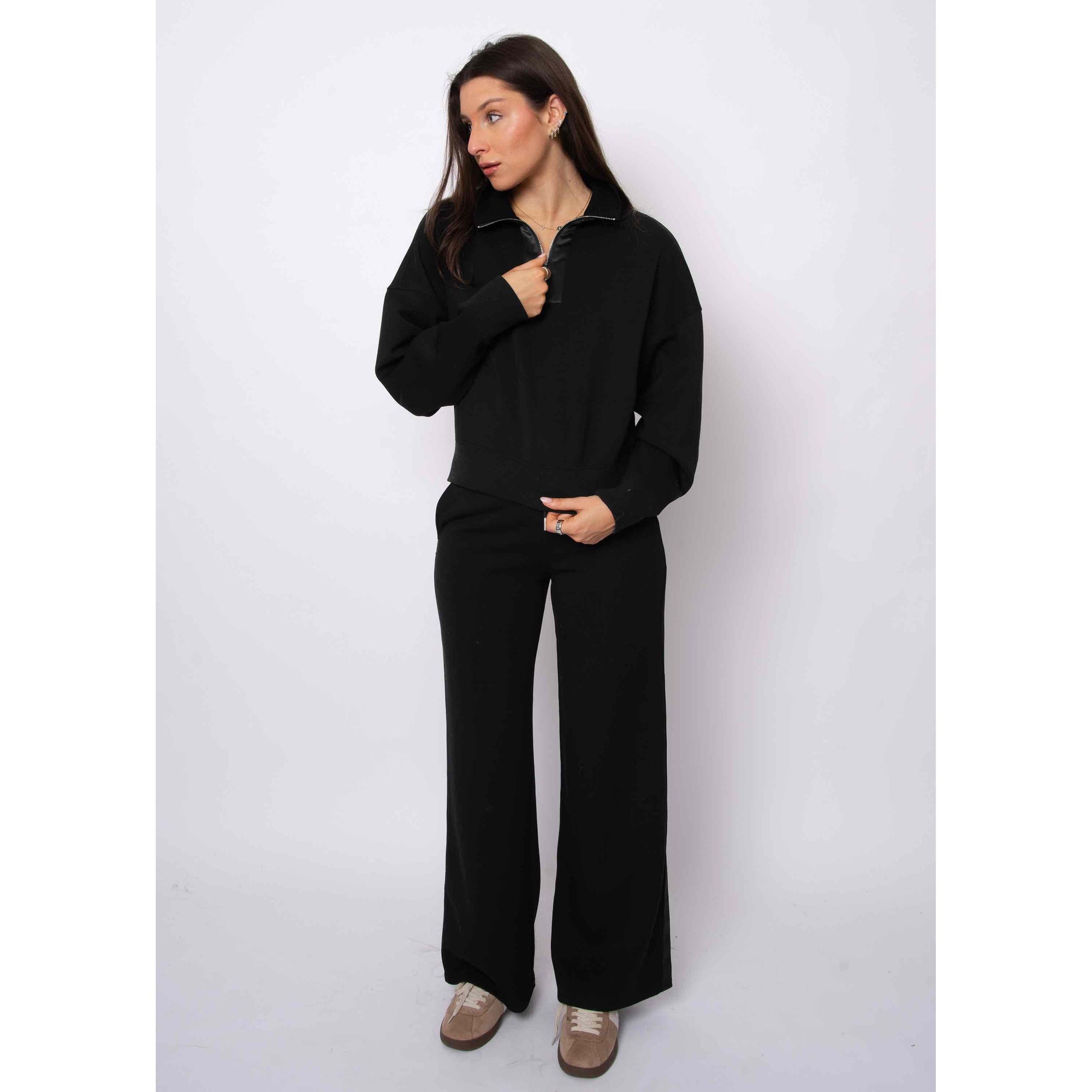 Woman wearing Mailyn Soft Knit w/ Satin Trim 1/2 Zip black cropped pullover with satin trim, relaxed fit.