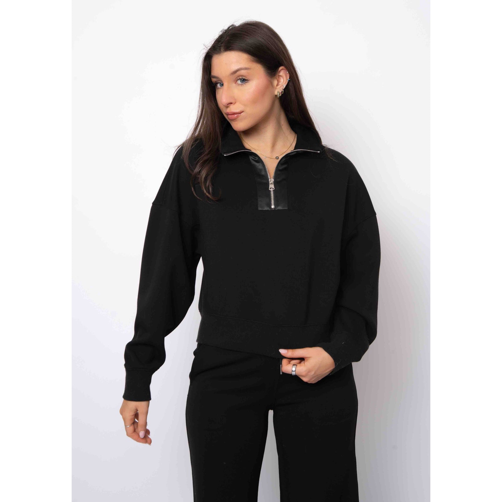 Model wearing black Mailyn Soft Knit half-zip with satin trim, cropped relaxed-fit pullover.