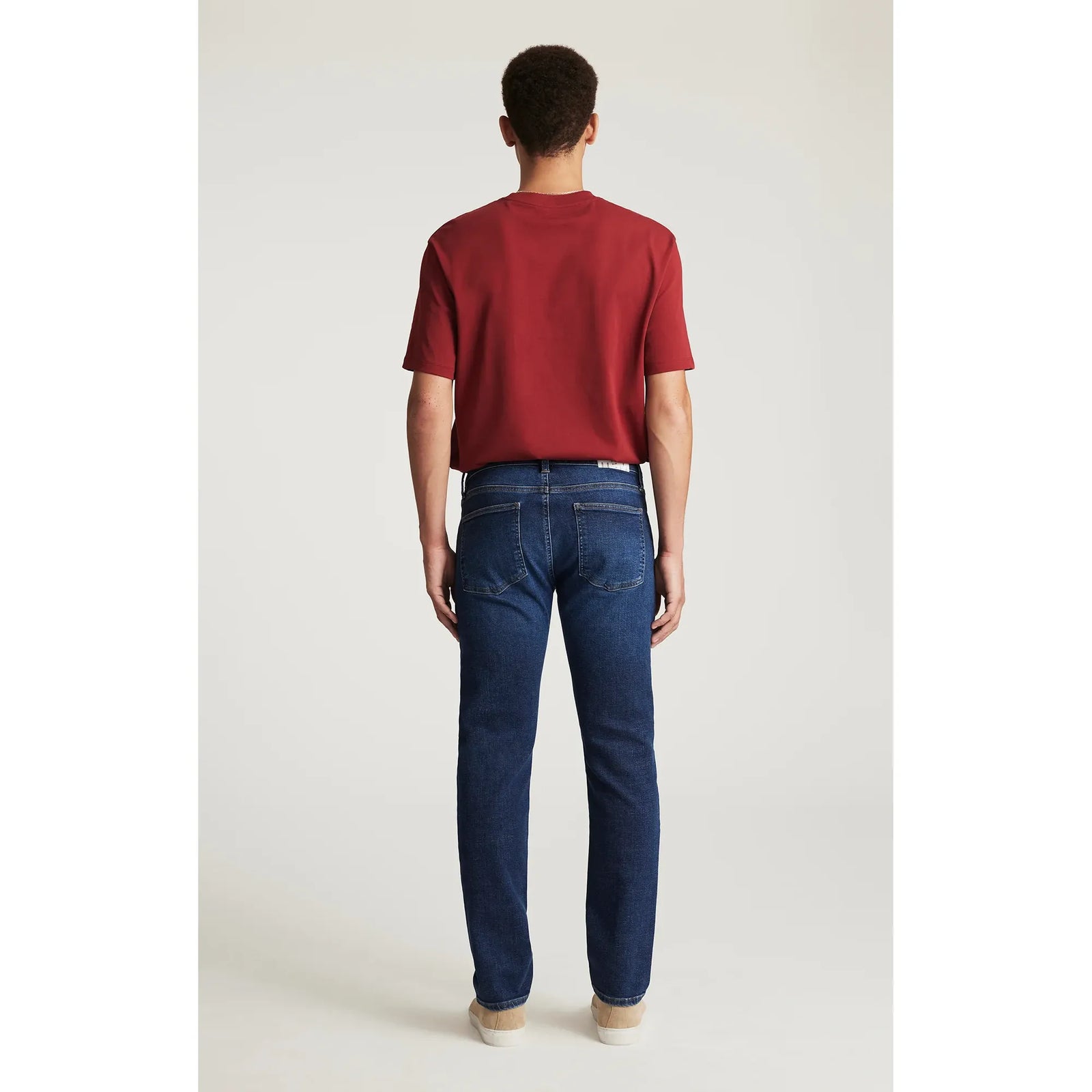 Back view of a model wearing Mavi Jake Rinse Dark Brushed Classic Vintage jeans with a slim fit and regular rise.