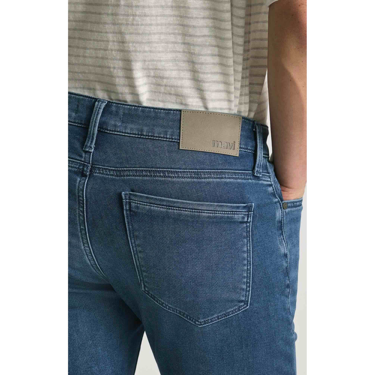 Mavi Jake Mid Explorer Denim jeans, back view in medium blue wash with tan leather waistband patch.