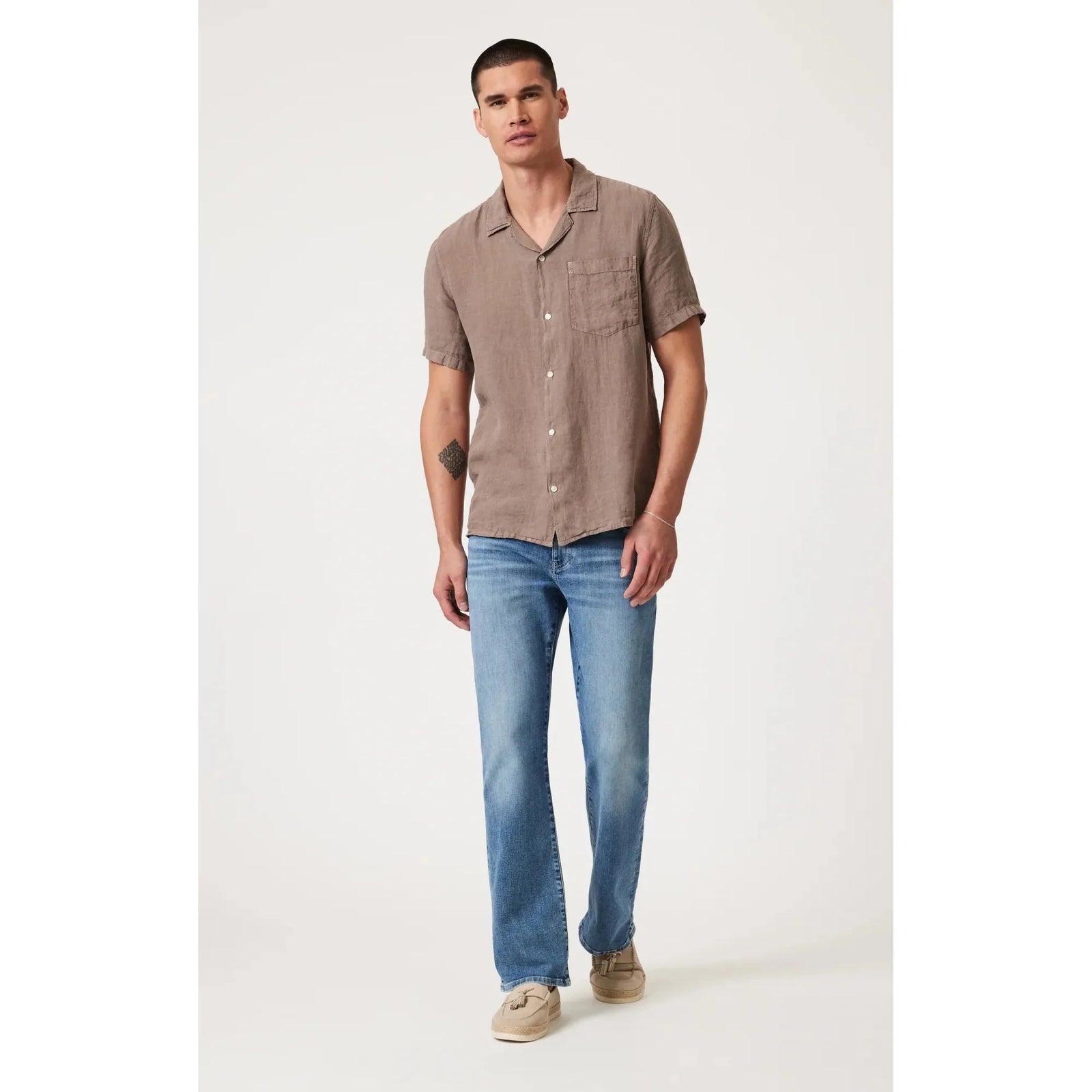 Stylish man wearing Mavi Josh Mid Brushed Classic Blue Bootcut jeans, perfect for comfort and versatility.