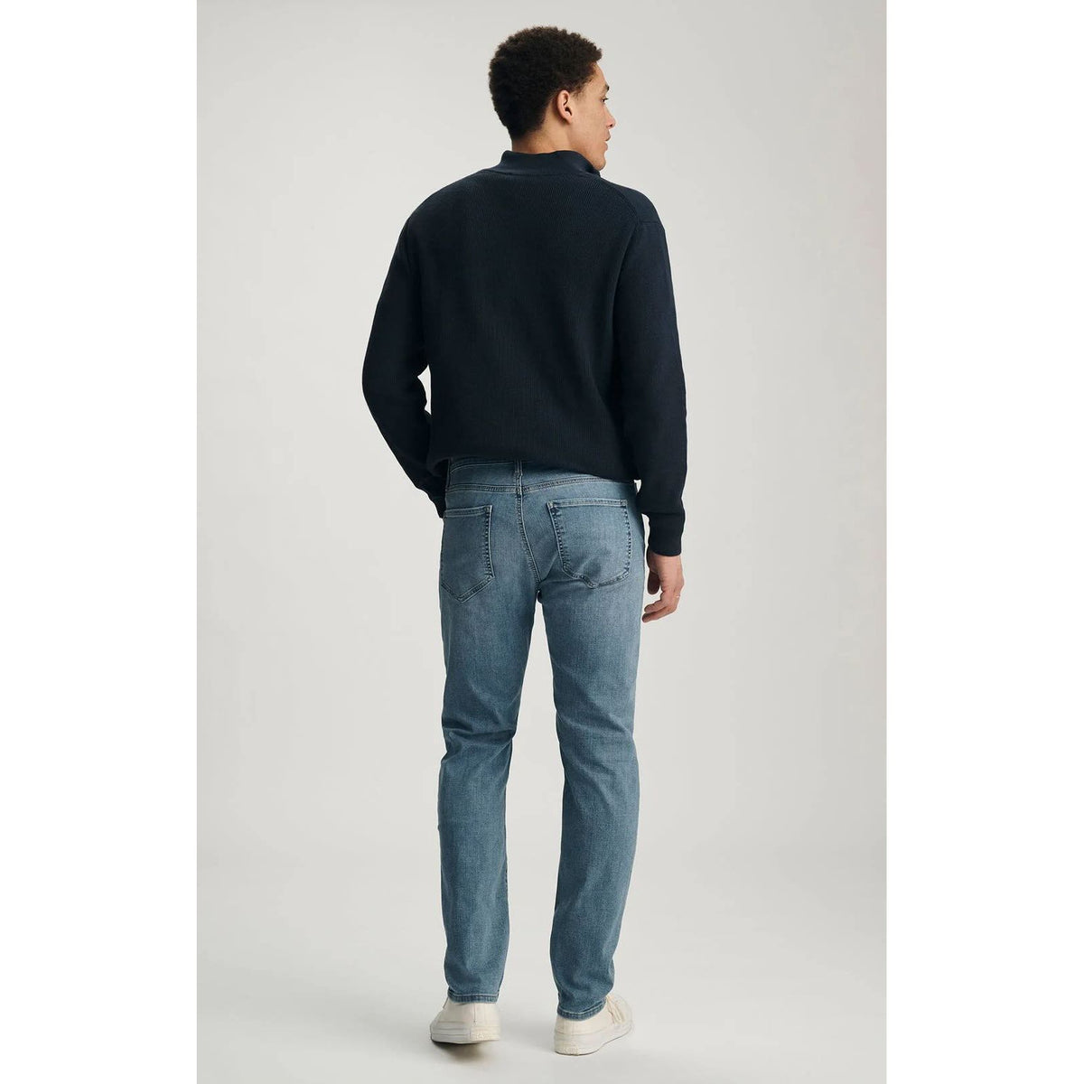 Back view of a man wearing blue Mavi Marcus Mid Brushed Organic Vintage Denim jeans.