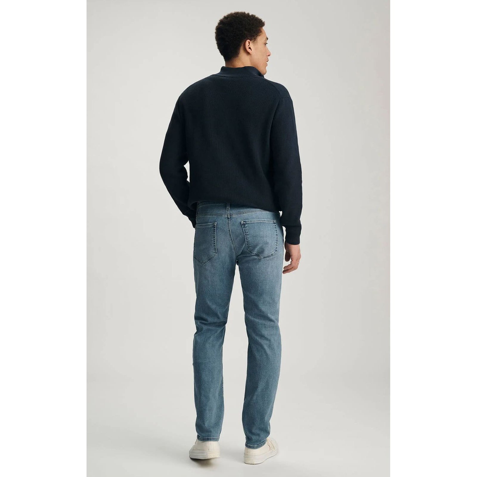 Back view of a man wearing blue Mavi Marcus Mid Brushed Organic Vintage Denim jeans.