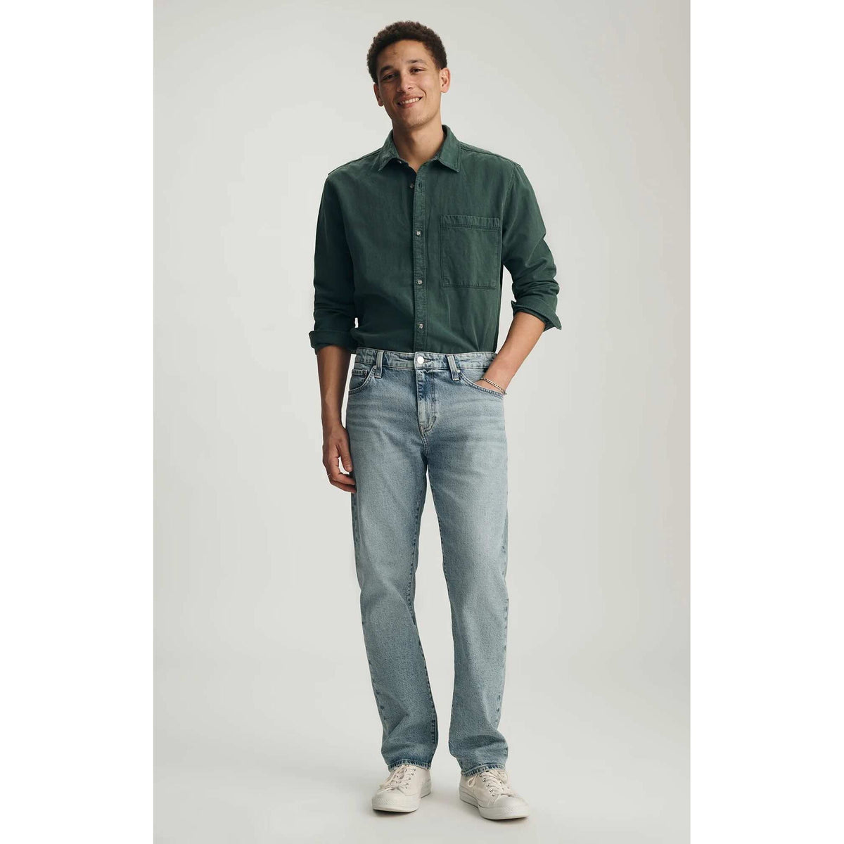 Model wearing Mavi Zach Lt Shaded Classic Blue Denim straight-leg jeans with a regular rise.