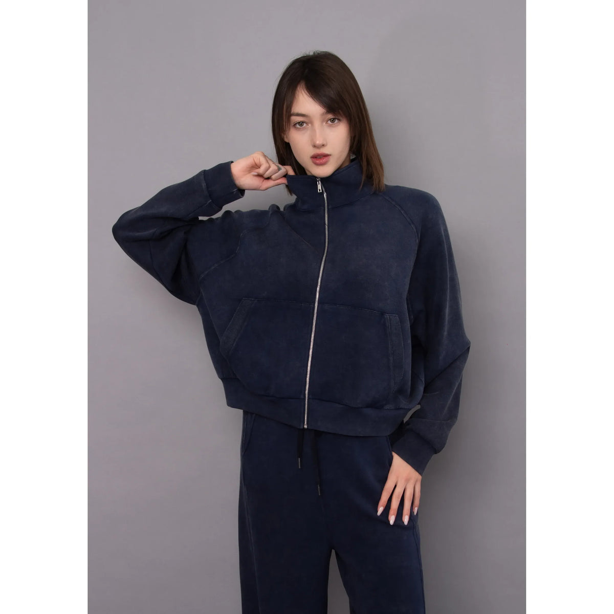 Ophelie Soft Knit Zip Up Top in mineral washed navy featuring a high collar, front kangaroo pocket, and relaxed fit.
