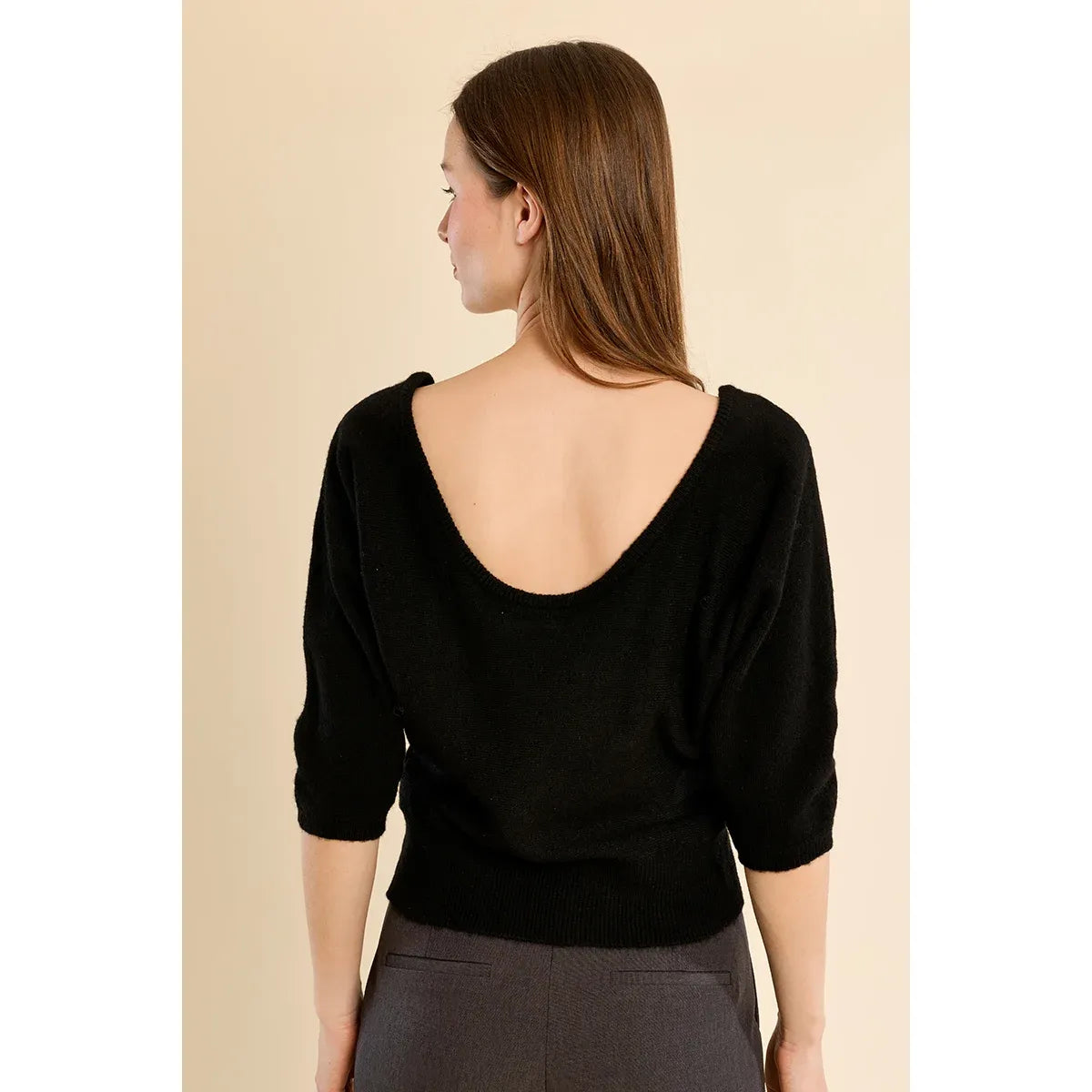 Black open-back 3/4 sleeve sweater featuring a boat neckline, relaxed fit, and ribbed hem.