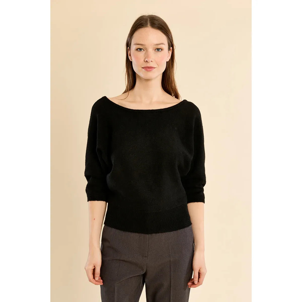 Black open-back knit sweater with boat neckline, three-quarter sleeves, and ribbed cuffs. Relaxed fit cozy comfort.