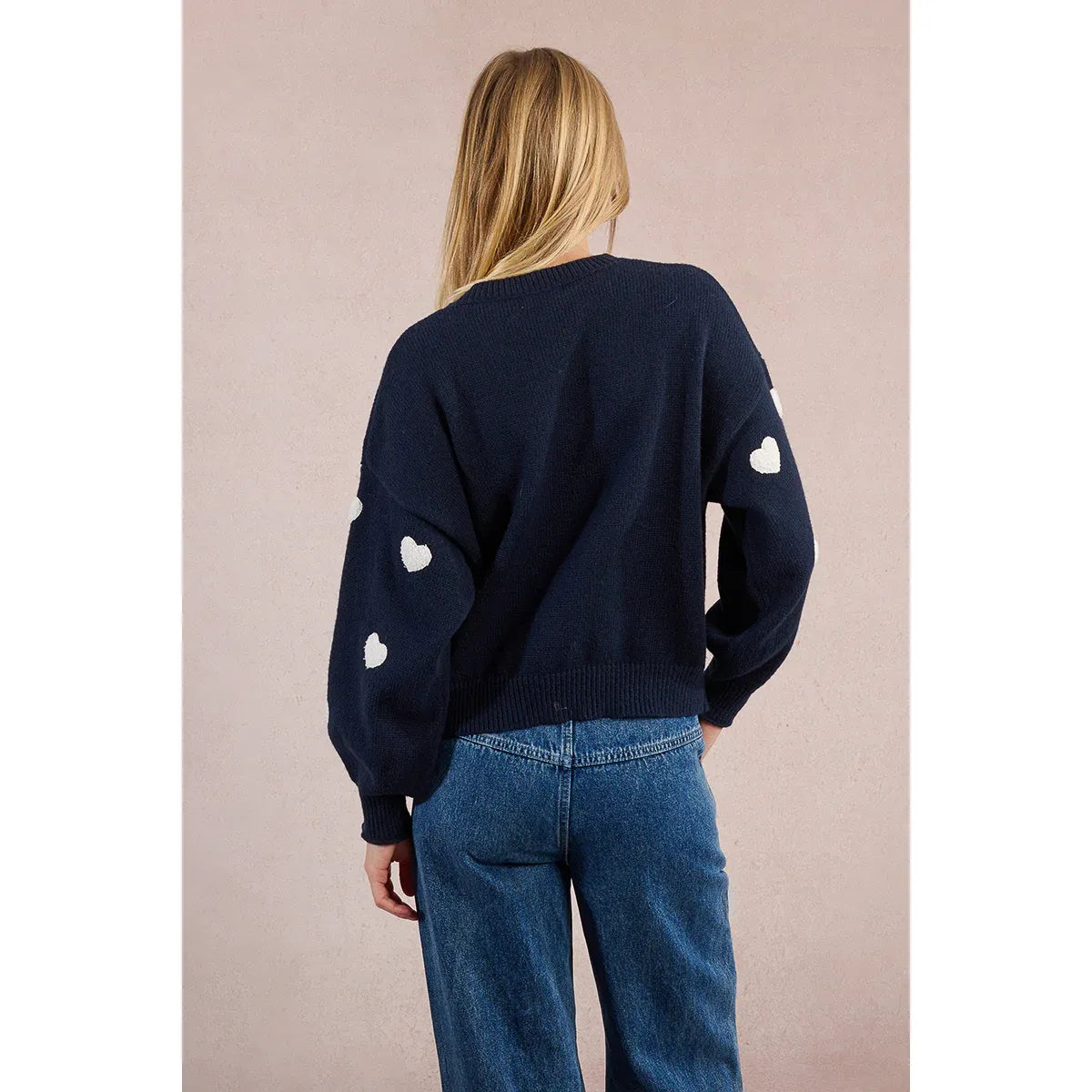 Back view of navy Molly Bracken Knitted Heart Crew Sweater with white heart patches on the sleeves.