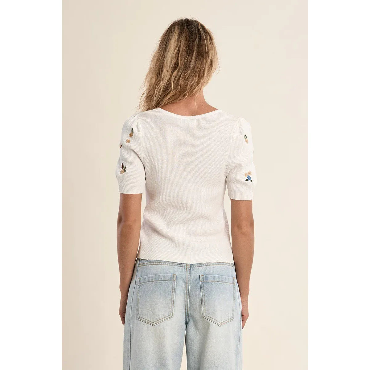 Back view of white Molly Bracken Embroidered Short Sleeve Sweater with floral embroidery on sleeves.