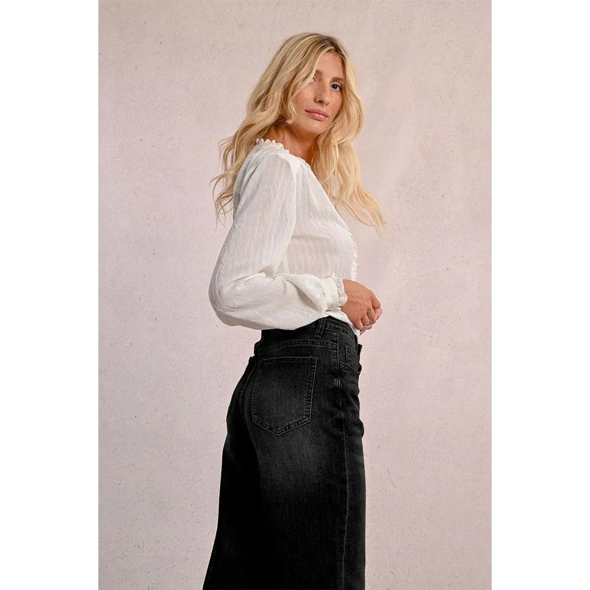 Model wearing Molly Bracken Jamie Wide Leg Black Denim Pants with a white blouse.
