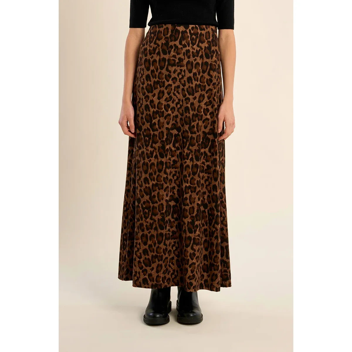 High-waisted leopard print maxi skirt with elastic waistband and straight fit, styled with black boots for fall.