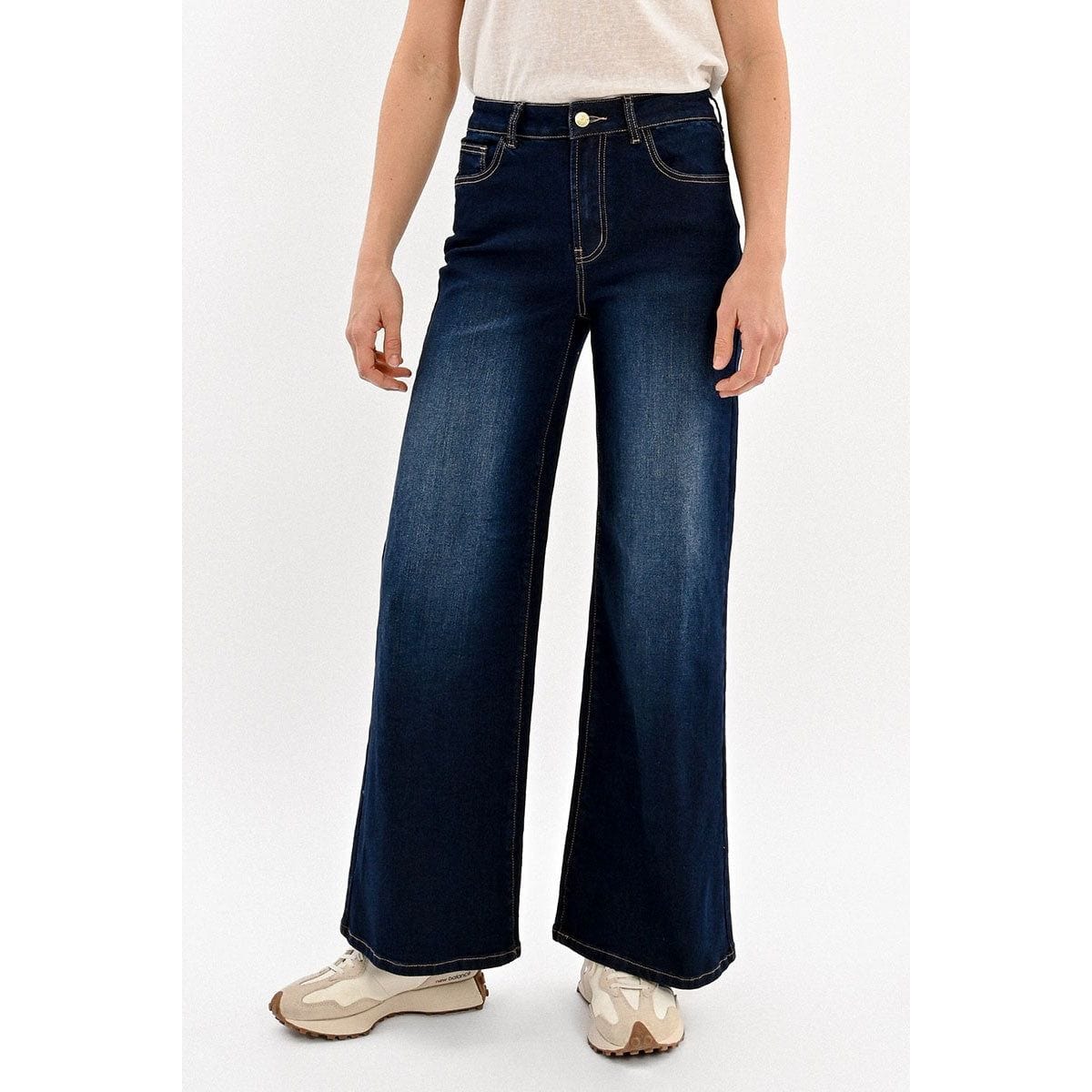 Model wearing Molly Bracken Jamie wide-leg denim pants in dark blue with light fading, front pockets, and zip fly.