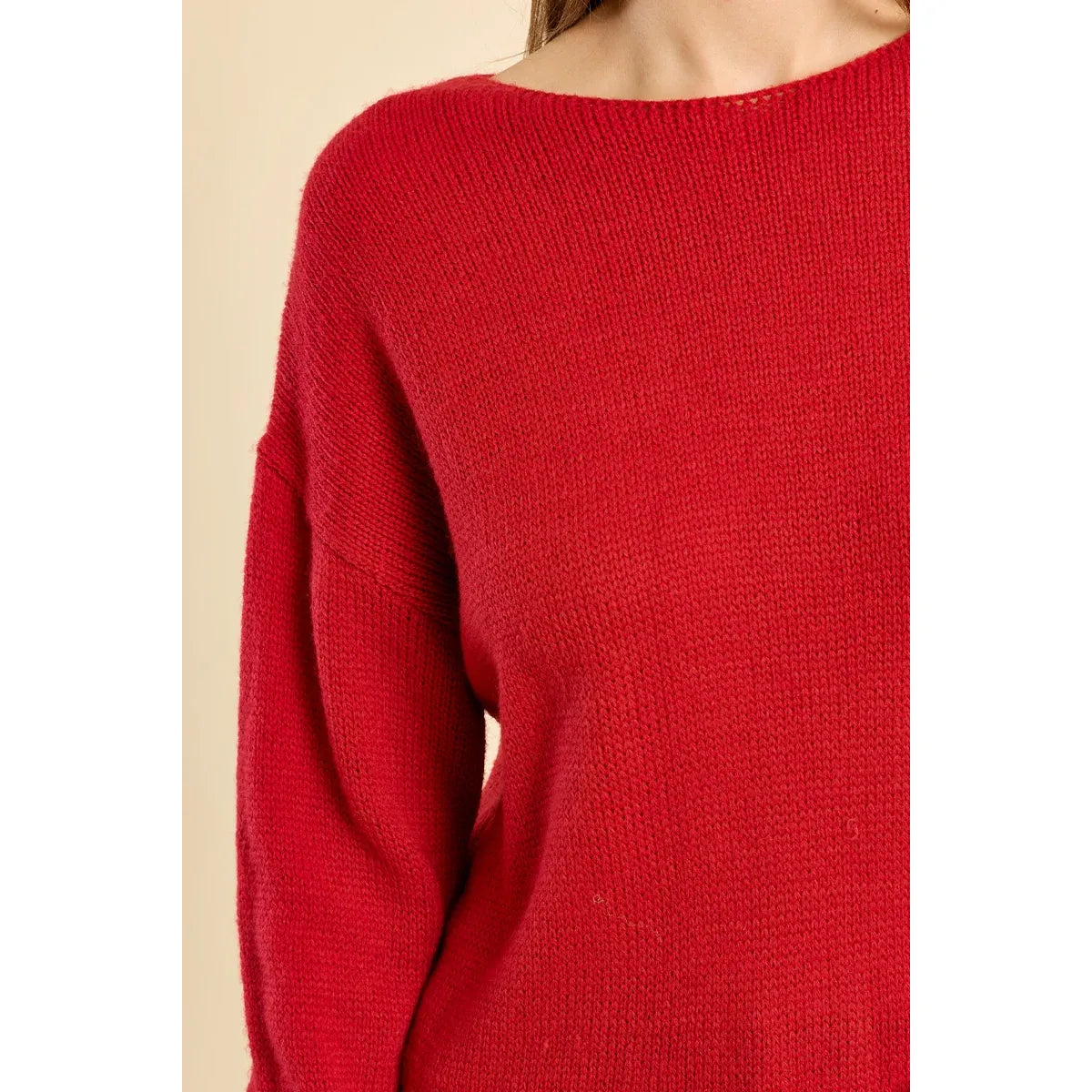 Red round neck knit sweater with relaxed fit, low armholes, and ribbed collar trim.