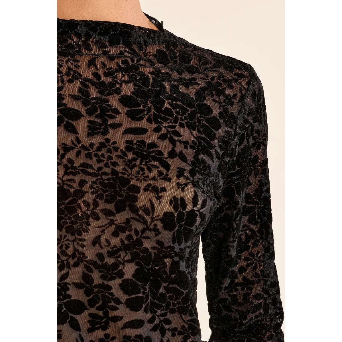 Black sheer lace mock neck top with long sleeves and floral pattern, featuring a stand-up collar and semi-transparent design.