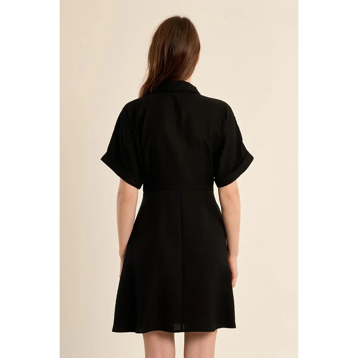Black short dress with knotted waist detail, relaxed silhouette, short sleeves, shirt collar, back view