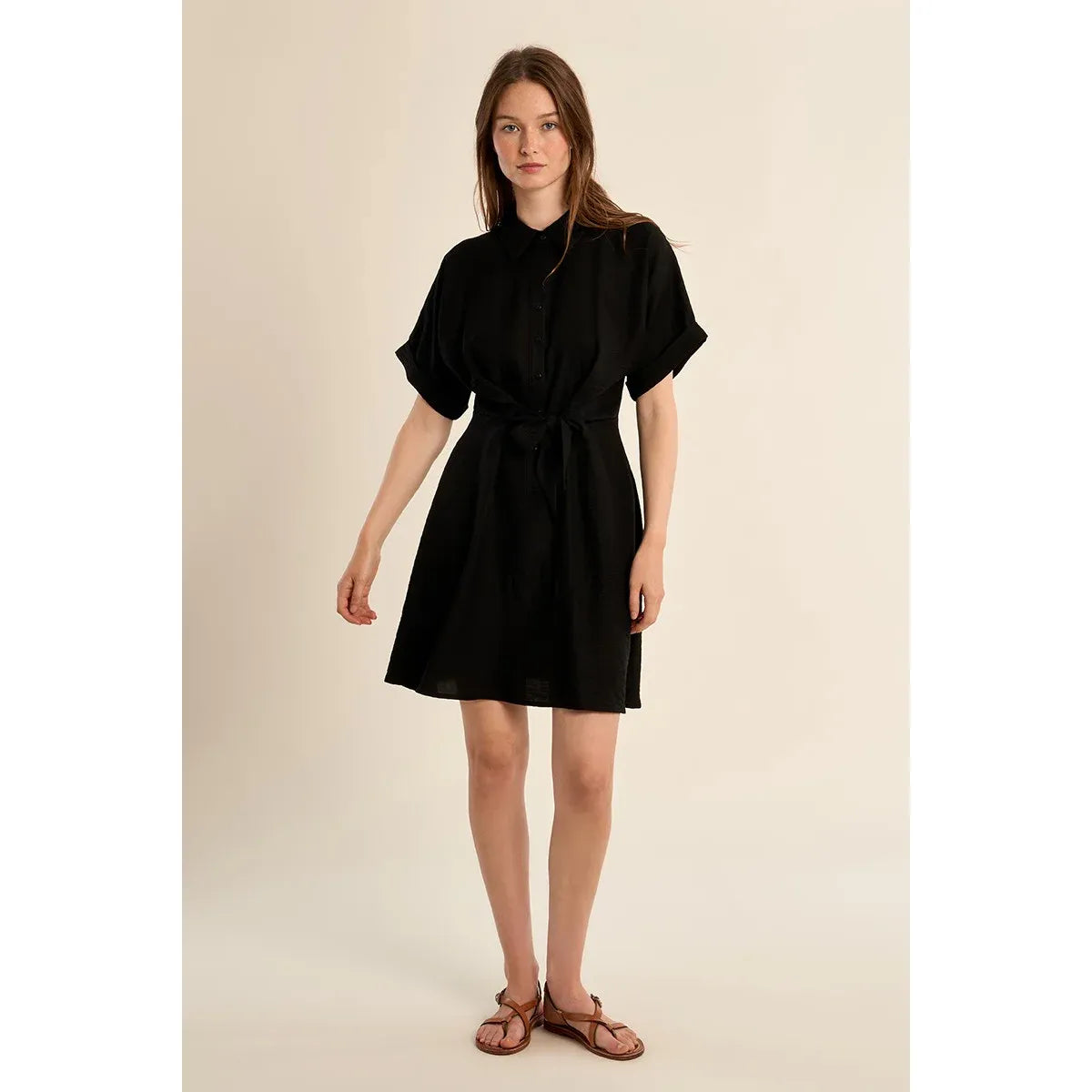 Molly Bracken Short Dress in black with knotted waist, short sleeves, shirt collar on model.
