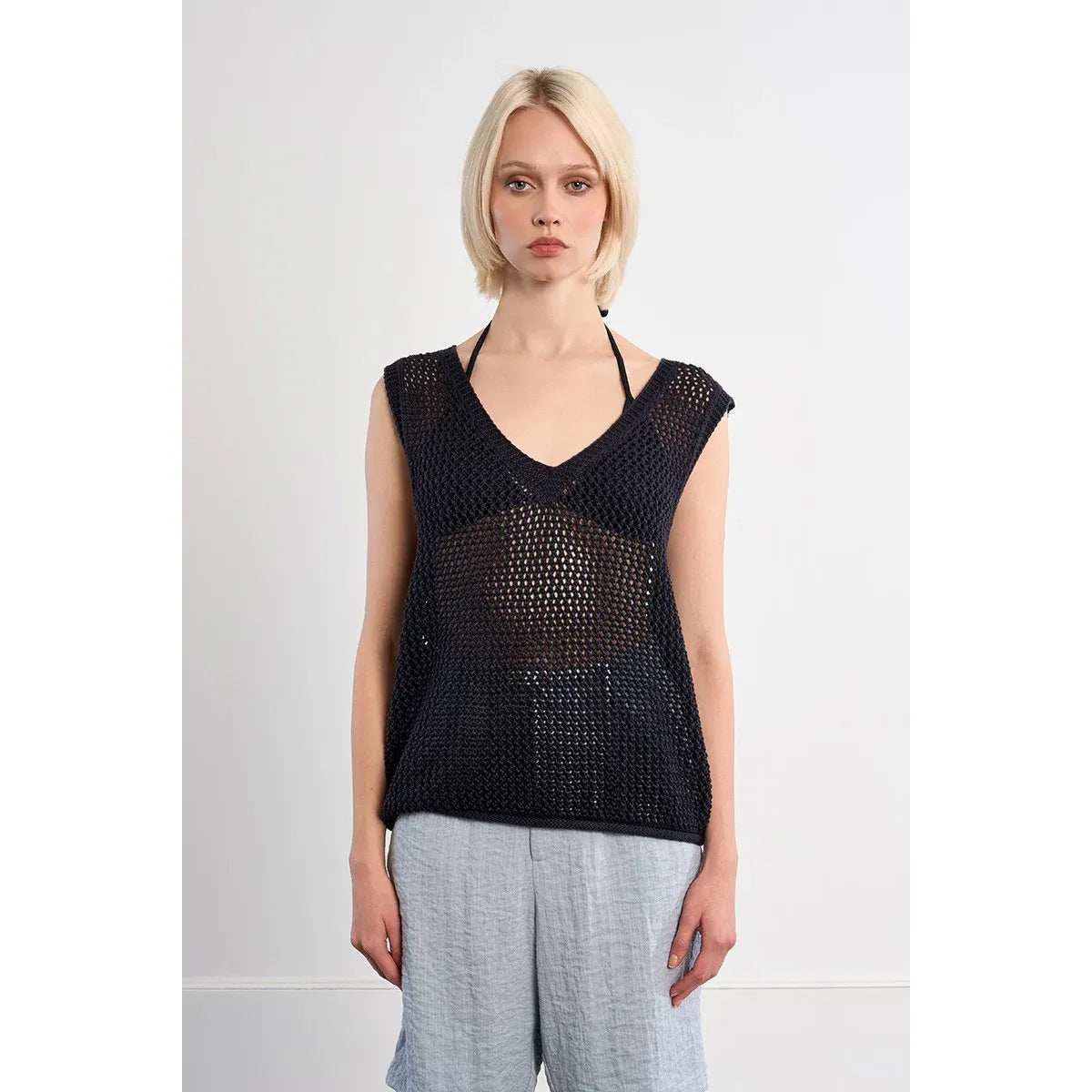 Molly Bracken Sleeveless Knit Top: black openwork knit with a relaxed V-neck and oversized silhouette.