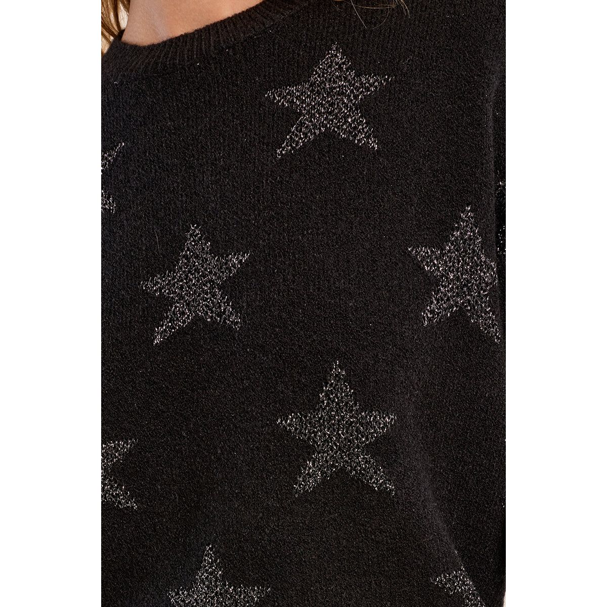 Black knit sweater with iridescent glittery star pattern, round neckline, and ribbed trim for a relaxed straight fit.