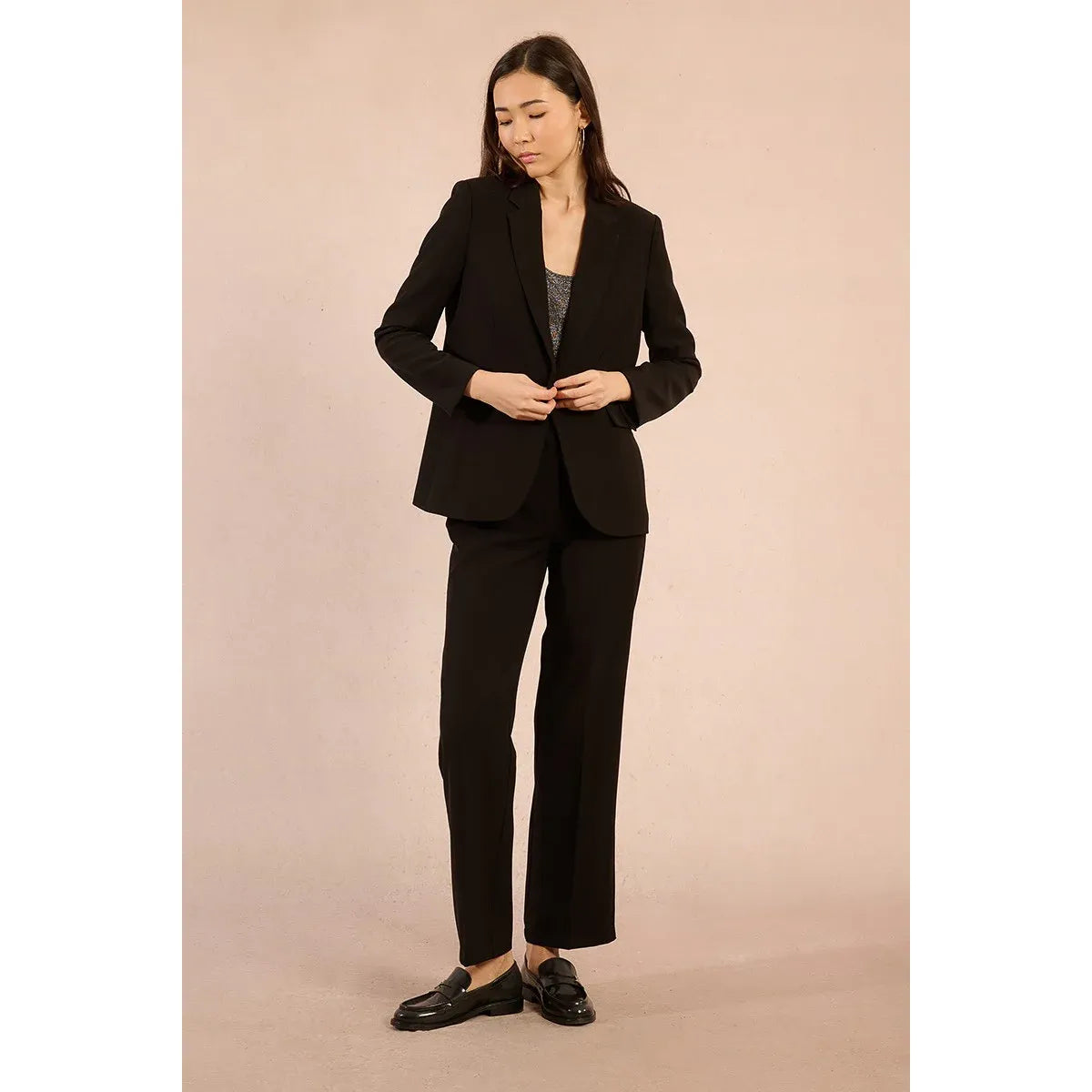 Model wearing Molly Bracken Woven Blazer in black with matching trousers, tailored, long sleeves, and wide collar.